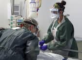 Nurses caring for a patient in an Intensive Care ward.
