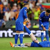 Rangers captain James Tavernier helps out John Lundstram with cramp during the Europa League final match against Eintracht Frankfurt. (Photo by Alex Pantling/Getty Images)