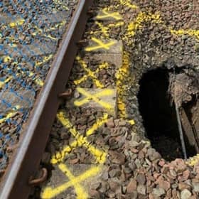 Network Rail engineers are working to repair a section of the line between Kilmarnock and Barassie after a large hole appeared close to the tracks.