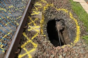 Network Rail engineers are working to repair a section of the line between Kilmarnock and Barassie after a large hole appeared close to the tracks.