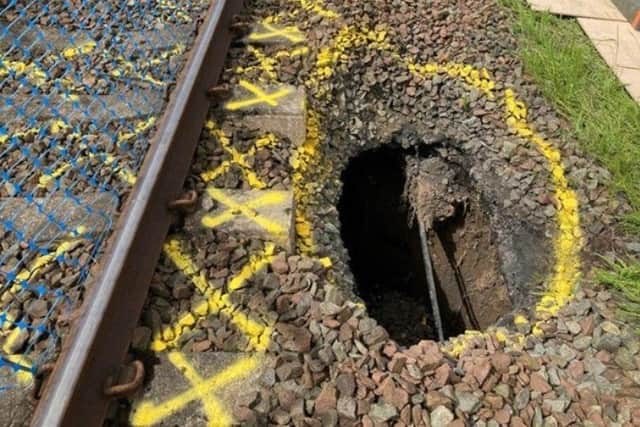 Network Rail engineers are working to repair a section of the line between Kilmarnock and Barassie after a large hole appeared close to the tracks.