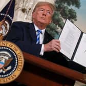 Then US President Donald Trump holds up a memorandum reinstating sanctions on Iran in 2018 (Picture: Chip Somodevilla/Getty Images)