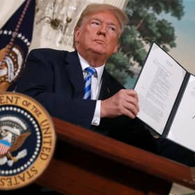 Then US President Donald Trump holds up a memorandum reinstating sanctions on Iran in 2018 (Picture: Chip Somodevilla/Getty Images)