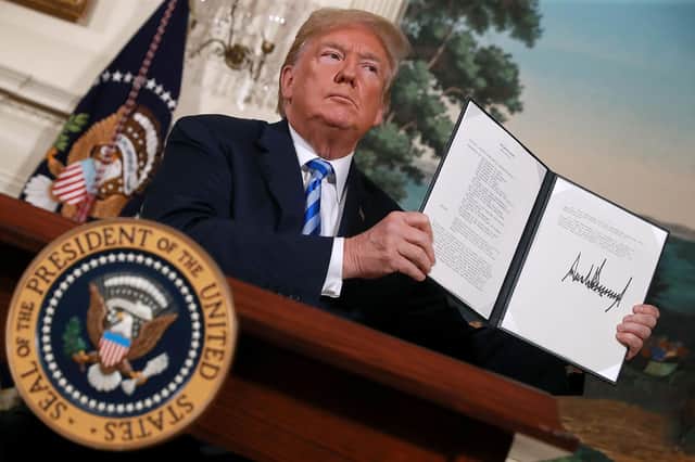 Then US President Donald Trump holds up a memorandum reinstating sanctions on Iran in 2018 (Picture: Chip Somodevilla/Getty Images)