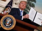 Then US President Donald Trump holds up a memorandum reinstating sanctions on Iran in 2018 (Picture: Chip Somodevilla/Getty Images)