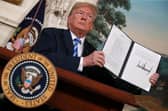 Then US President Donald Trump holds up a memorandum reinstating sanctions on Iran in 2018 (Picture: Chip Somodevilla/Getty Images)