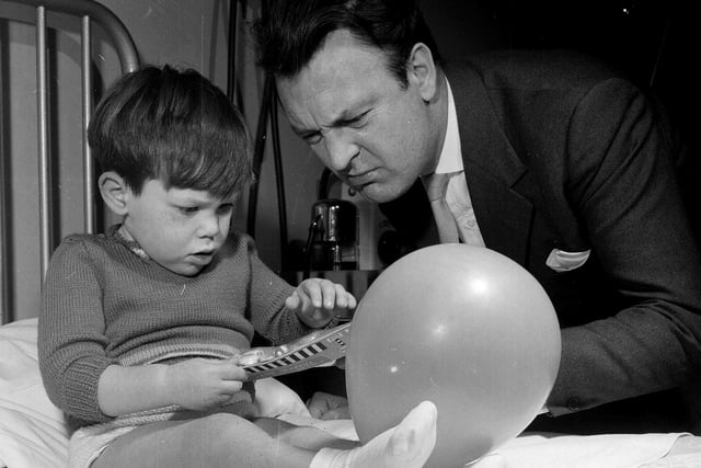Actor Donald Sinden visits Edinburgh's Royal Hospital for Sick Children in December 1962 to deliver Christmas presents to the young patients.