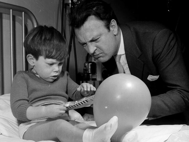 Actor Donald Sinden visits Edinburgh's Royal Hospital for Sick Children in December 1962 to deliver Christmas presents to the young patients.