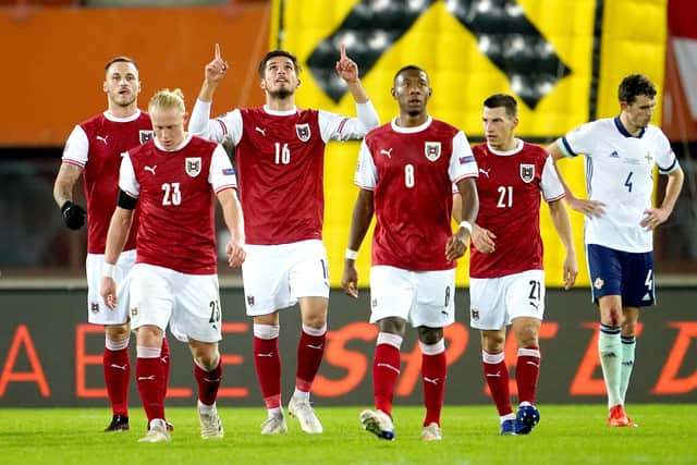 Adrian Grbic (number 16) celebrates a goal for Austria against Northern Ireland in a UEFA Nations League match in Vienna last November. (Photo by GEORG HOCHMUTH/APA/AFP via Getty Images)