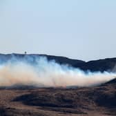 A helicopter douses a wild fire with water on the Isle of Bute on April 10 in Colintraive, Scotland. (Photo by Jeff J Mitchell/Getty Images)