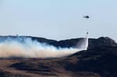 A helicopter douses a wild fire with water on the Isle of Bute on April 10 in Colintraive, Scotland. (Photo by Jeff J Mitchell/Getty Images)