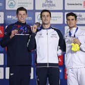 Italy's Alberto Razzetti, centre, celebrates his gold medal in Men's 400m Individual Medley with second placed Britain's Duncan Scott, left, and third Greece's Apostolos Papastamos.
