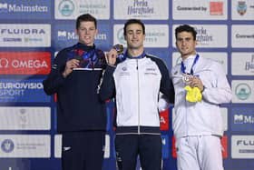 Italy's Alberto Razzetti, centre, celebrates his gold medal in Men's 400m Individual Medley with second placed Britain's Duncan Scott, left, and third Greece's Apostolos Papastamos.