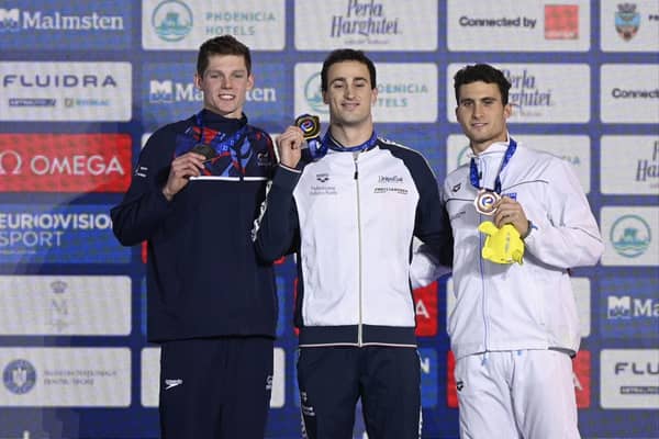 Italy's Alberto Razzetti, centre, celebrates his gold medal in Men's 400m Individual Medley with second placed Britain's Duncan Scott, left, and third Greece's Apostolos Papastamos.