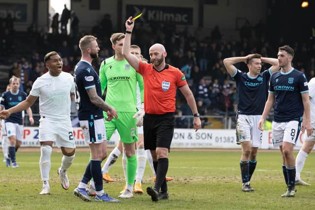 Referee Bobby Madden shows Christie Elliott a yellow card.  (Photo by Alan Harvey / SNS Group)