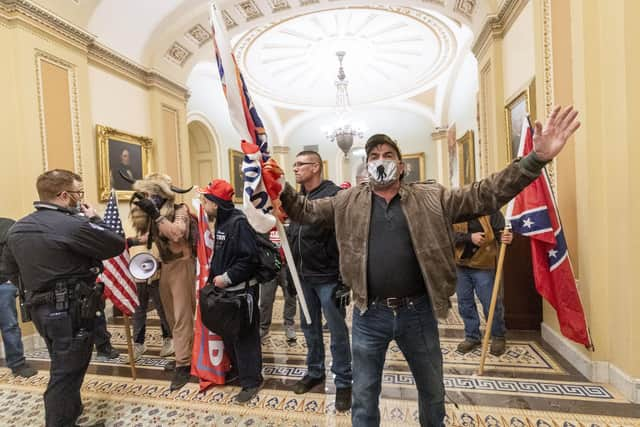 Supporters of President Donald Trump are confronted by U.S. Capitol Police officers outside the Senate Chamber inside the Capitol