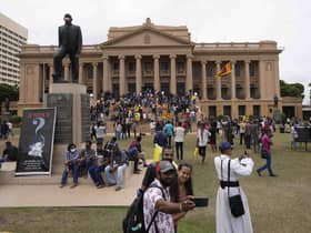 Protesters walk around and spend time at the ongoing protest site a day after storming into president's office in Colombo, Sri Lanka, Sunday, July 10, 2022. Sri Lankaâ€™s opposition political parties will meet Sunday to agree on a new government a day after the countryâ€™s president and prime minister offered to resign in the countryâ€™s most chaotic day in months of political turmoil, with protesters storming both officialsâ€™ homes and setting fire to one of the buildings in a rage over the nationâ€™s economic crisis. (AP Photo/Eranga Jayawardena)