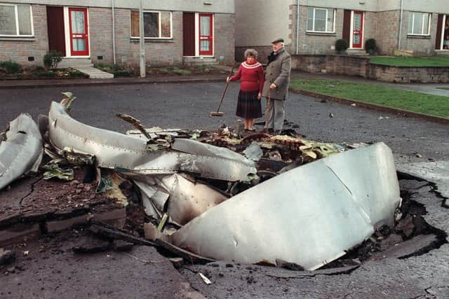 Local resident Robert Love stands by one of the four engines of the ill-fated Pan Am 747 Jumbo jet, the day after it exploded and crashed on 21 December on the route to New York. PIc: ROY LETKEY/AFP via Getty Images