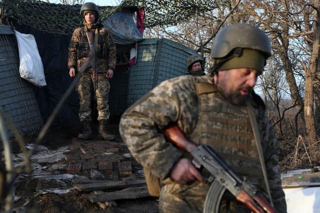 Servicemen of the Ukrainian Military Forces walk on the front line with Russian-backed separatists near Novohnativka, Donetsk region, on February 20, 2022.
