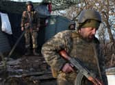 Servicemen of the Ukrainian Military Forces walk on the front line with Russian-backed separatists near Novohnativka, Donetsk region, on February 20, 2022.