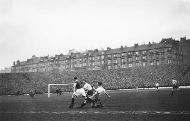 Apr 1923:  Morgan of Scotland beats two English defenders during the Home Championship match at Hampden Park, Glasgow.  The game finished in a 2-2 draw with goals from Cunningham and Wilson for Scotland and Kelly and Watson for England. Mandatory Credit: Allsport Hulton/Archive