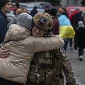 A woman hugs a Ukrainian officer as they celebrate the recapture of Kherson from Russian forces. Picture: AP