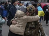 A woman hugs a Ukrainian officer as they celebrate the recapture of Kherson from Russian forces. Picture: AP