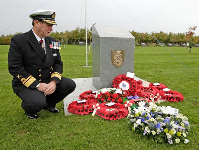 Rear Admiral Philip Wilcocks, whose uncle Eric Wilcocks was killed on HMS Hood, pays his respects at a memorial in the National Arboretum Memorial Park dedicated to the 1,415 crew who lost their lives when the ship was sunk (Picture: Rebecca Mckevitt/SWNS)