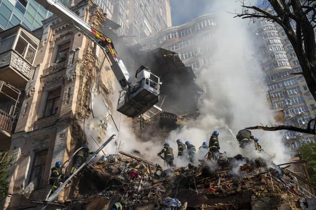 Firefighters work after a drone attack on buildings in Kyiv, Ukraine, on  Oct. 17, 2022. President Volodymyr Zelensky said nearly a third of Ukraine’s power stations have been destroyed in the past week, “causing massive blackouts across the country”.

 (AP Photo/Roman Hrytsyna)