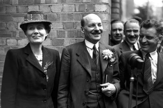 Labour leader Clement Attlee and his wife Violet were cheered by supporters outside Labour HQ at Transport House after the party's victory