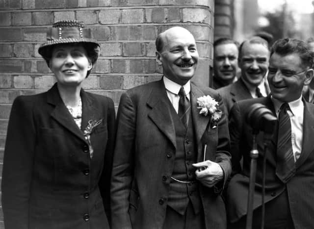 Labour leader Clement Attlee and his wife Violet were cheered by supporters outside Labour HQ at Transport House after the party's victory