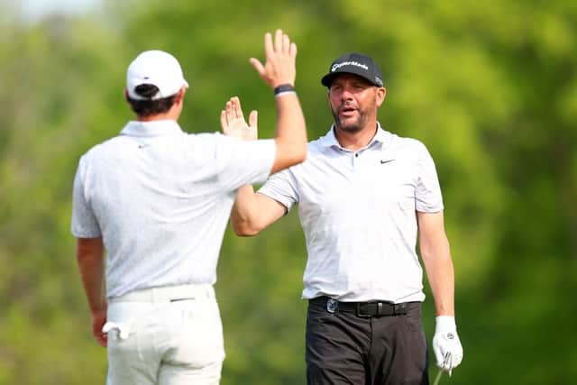Michael Block is congratulated by playing partner Rory McIlroy after making a hole-in-one during the final round of the PGA Championship at Oak Hill Country Club in May. Picture: Andrew Redington/Getty Images.