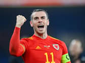 Gareth Bale celebrates after leading Wales to a 2-1 victory in the World Cup play-off semi-final against Austria. (Photo by Dan Mullan/Getty Images)