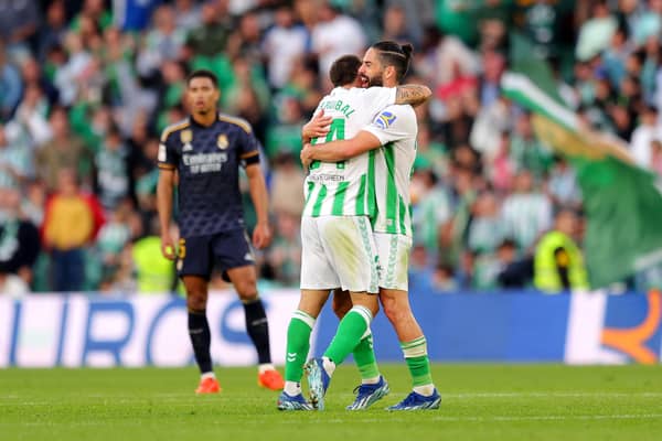 Aitor Ruibal of Real Betis (obscured) celebrates scoring their team's first goal with team mate Isco against Real Madrid.