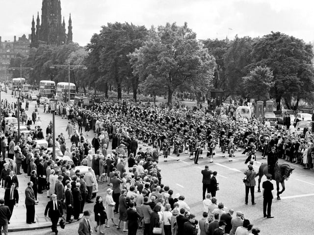 More Edinburgh International Festival fun, this time in August 1966 when crowds gathered to watch the Edinburgh City Police Pipe Band as it marched along Princes Street.