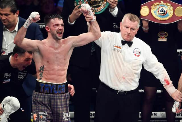 Josh Taylor (L) is declared the victor over Jack Catterall during the WBA, WBC, WBO & IBF world super-lightweight title fight at the OVO Hydro.
