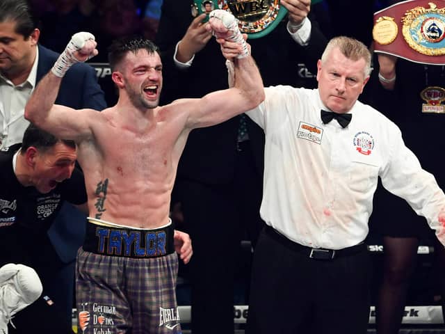 Josh Taylor (L) is declared the victor over Jack Catterall during the WBA, WBC, WBO & IBF world super-lightweight title fight at the OVO Hydro.