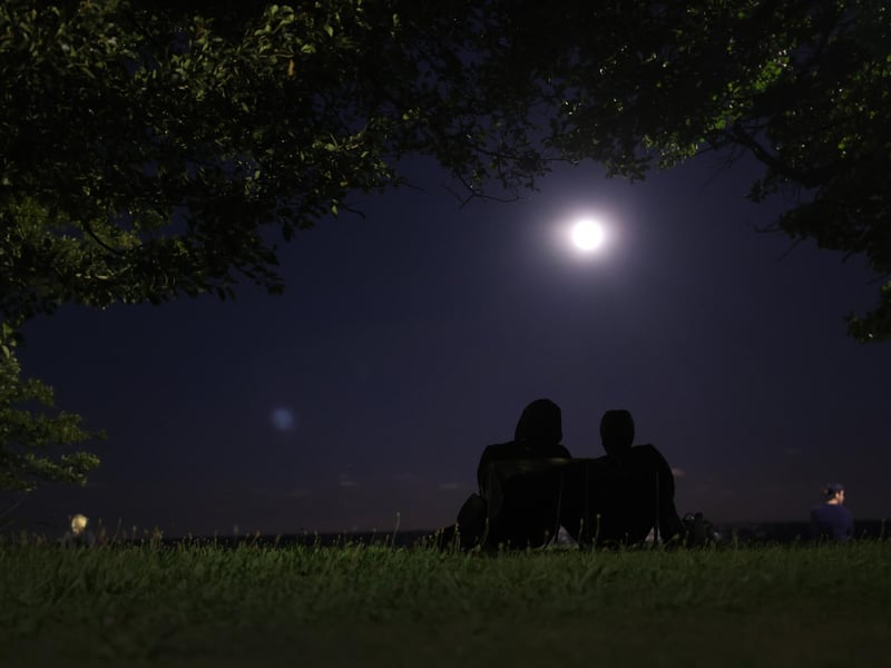 People gather along North Avenue Beach as a super blue moon rises in Chicago, Illinois. (Photo by Scott Olson/Getty Images)