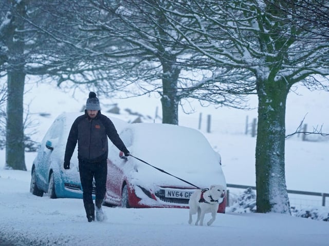 A man walks his dog in Tow Law, Co Durham