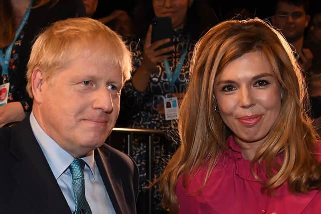 Prime Minister Boris Johnson with his partner Carrie Symonds  (Photo by JEREMY SELWYN/POOL/AFP via Getty Images)