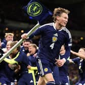 A jubilant Scott McTominay celebrates World Cup qualification after beating Denmark (Picture: Stu Forster/Getty Images)