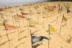 The Beach of Dreams Silks is a dynamic and travelling silk installation composed of hundreds of naturally-dyed pennants, each representing a personal story that reflects our relationship with the coast and sea.
