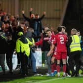 Raith fans spill on to the pitch after Brad Spencer's late equaliser.