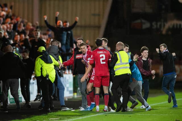 Raith fans spill on to the pitch after Brad Spencer's late equaliser.
