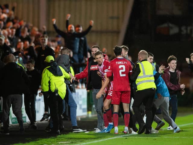 Raith fans spill on to the pitch after Brad Spencer's late equaliser.