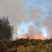 A wildfire burns close to electricity pylons near Cannich in the Highlands in a sign of one of the direct threats that climate change will increasingly pose (Picture: FLS)