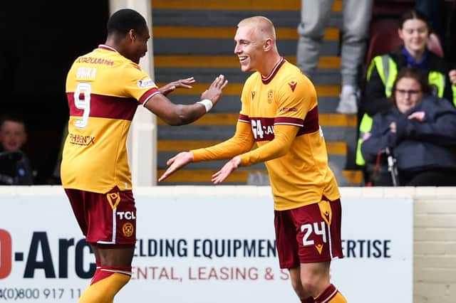 Motherwell's Mika Biereth (R) takes the plaudits from fellow sub Jon Obika after scoring his side's second goal v Hibs (Photo by Ross MacDonald / SNS Group)