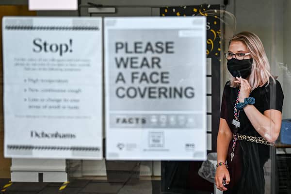 A shopper in Princes Street wears a mask.