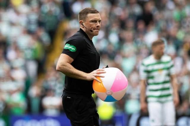 Referee John Beaton removes a beachball from the pitch area during a cinch Premiership match between Celtic and Rangers at Celtic Park, on May 01, 2022, in Glasgow, Scotland.  (Photo by Craig Williamson / SNS Group)