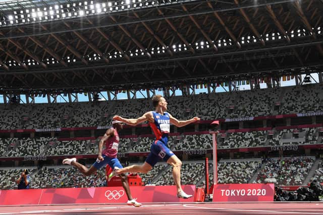 Norway's Karsten Warholm, right, crosses the finish line to win the Olympic 400m and break the world record ahead of second-placed Rai Benjamin of the USA. Picture: Jewel Samad/AFP via Getty Images